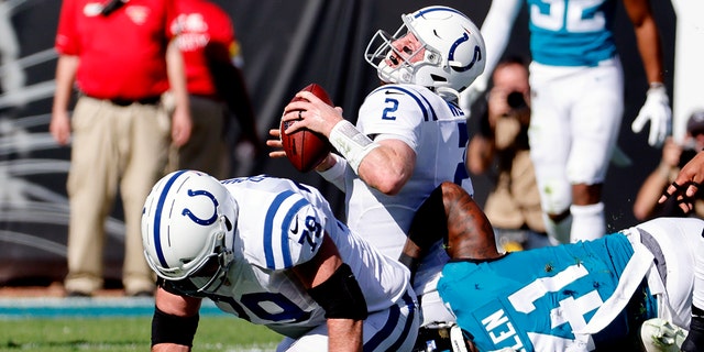 Indianapolis Colts quarterback Carson Wentz (2) is sacked by Jacksonville Jaguars outside linebacker Josh Allen (41) during the first half of an NFL football game, Sunday, Jan. 9, 2022, in Jacksonville, Fla.