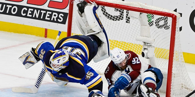 Colorado Avalanche left wing Gabriel Landeskog (92) slides into the net, upending St. Louis Blues goaltender Ville Husso (35) in the third period during Game 6 of the second round of the NHL Stanley Cup playoffs at the Enterprise Center May 27, 2022.