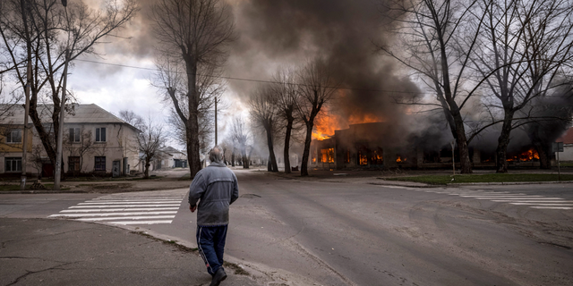 A man walks on a street in Severodonetsk, eastern Ukraine, following shelling there on Wednesday.
