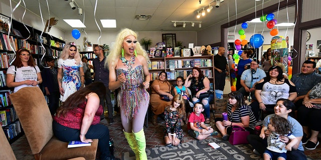 Drag queens Athena Kills and Scalene Onixxx arrive to awaiting adults and children for "Drag Queen Story Hour" at Cellar Door Books in Riverside, California on June 22, 2019.