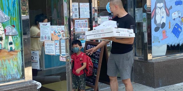 Father dropping off son at Daycare for Pizza Party, Queens, New York.