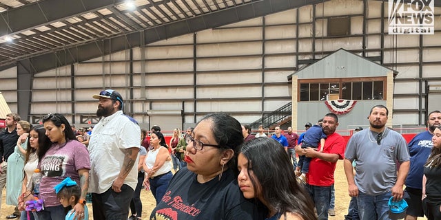 A mother and daughter attend the Uvalde, Texas candlelight vigil.
