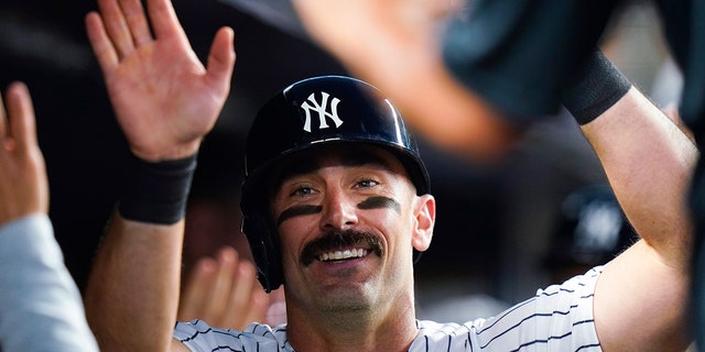 The New York Yankees' Matt Carpenter is congratulated in the dugout after hitting a two-run home run during the fifth inning of the team's game against the Detroit Tigers Friday, June 3, 2022, in New York.