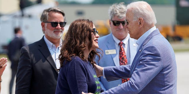 U.S. President Joe Biden greets Michigan Governor Gretchen Whitmer as he arrives in Traverse City, Michigan, U.S., July 3, 2021.